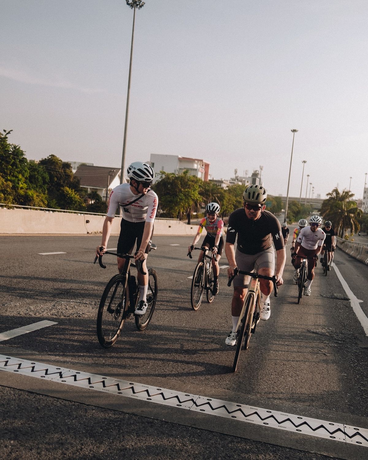 Group of cyclists riding together on a road